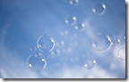 Bubbles float in blue sky
