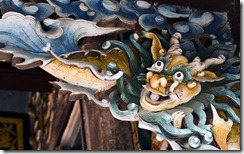 Ornately carved wooden bracket depicting Vietnamese dragon, above doorway, Hoi An, Vietnam